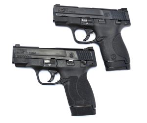 Two Smith and Wesson Shield pistols, left profile, concealed carry