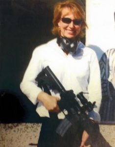 Gabrielle Giffords posing with an AR-15 rifle.