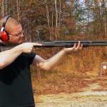 Man shooting a Mossberg 500 shotgun