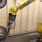 Robotic arm precision grinding a gun barrel