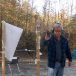 Handgun pointed at the camera