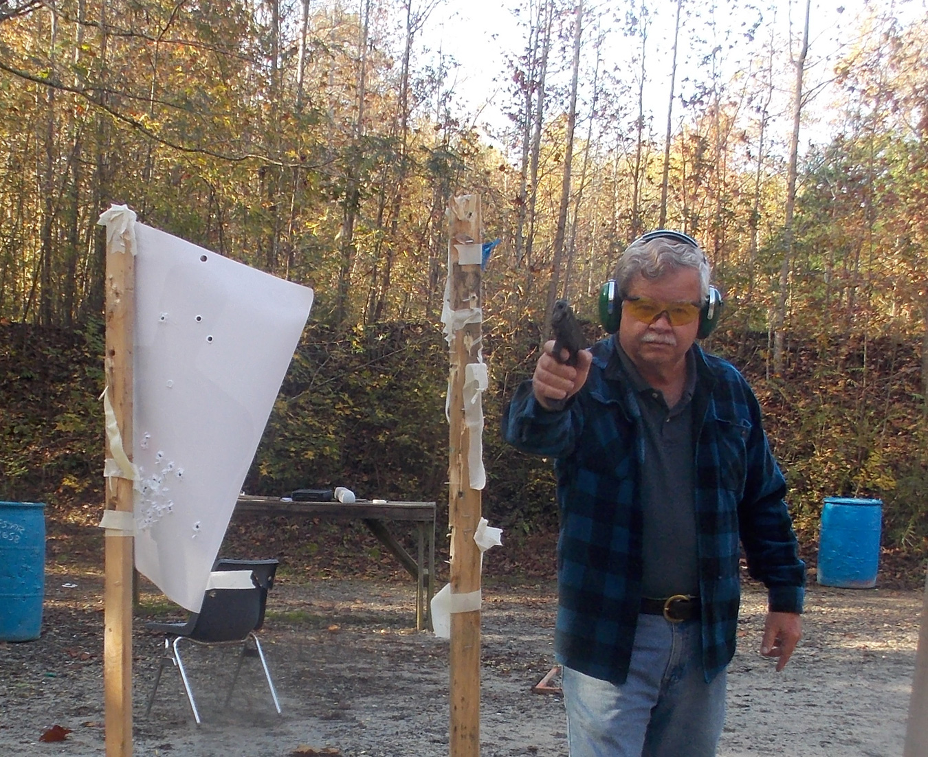 Handgun pointed at the camera