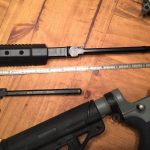 HABU AR-15 charging handle next to a ruler