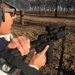 Rear view charging an AR-15 with the HABU handle