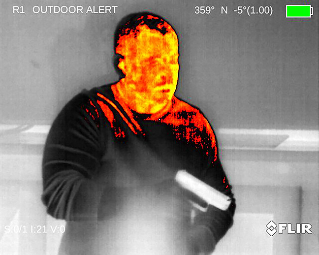 Thermal image of an intruder with a pistol
