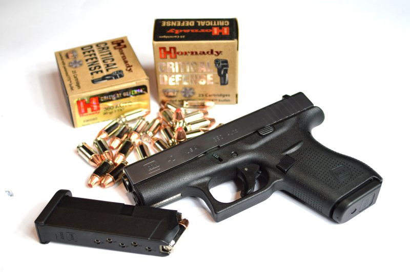 Glock G42 with two boxes of Hornady Critical Defense ammunition