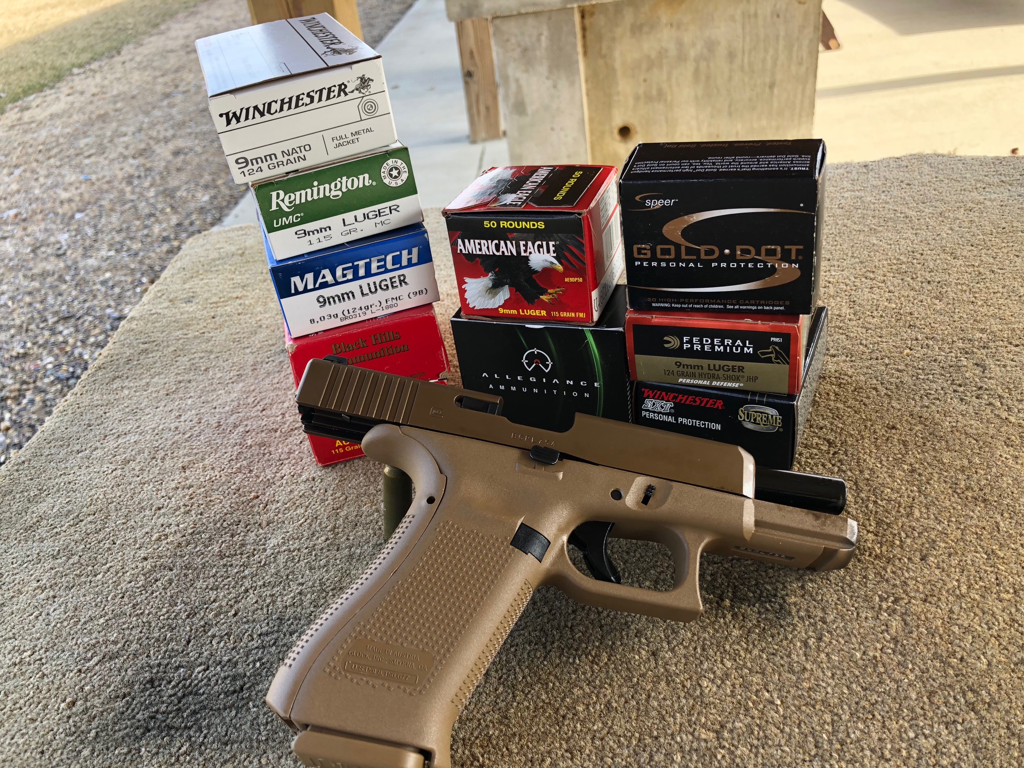 Glock 19X with several boxes of different brands of ammunition