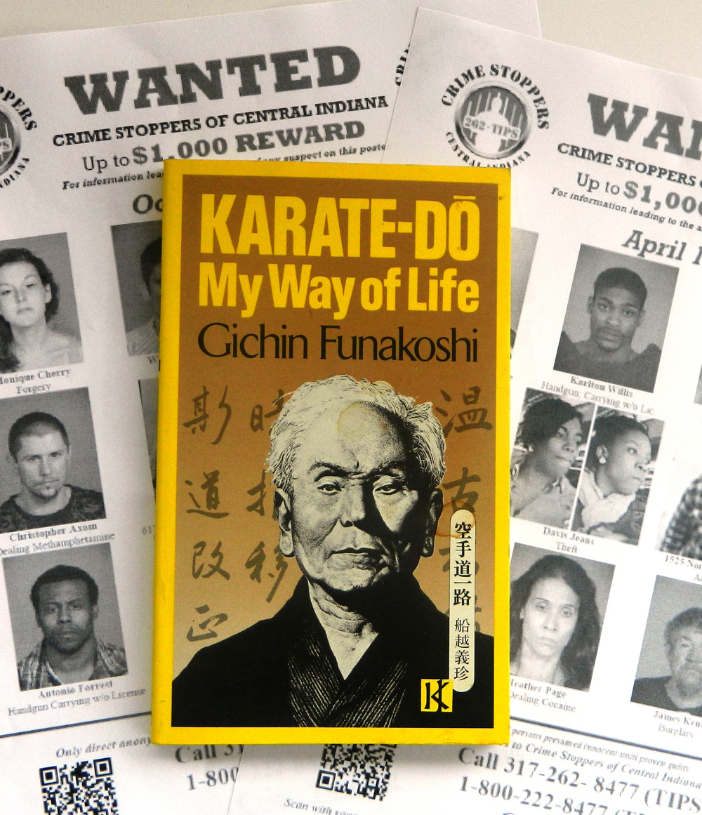 Wanted posters with a book by Gichin Funakoshi