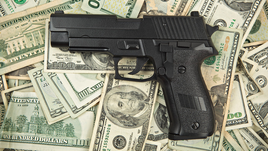 SIG Sauer pistol on 100 dollar bills