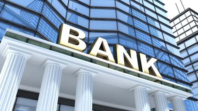 banks sign on glass building with roman columns
