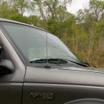 Windshield and hood of a silver pickup truck