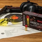 .45 ACP Syntech ammunition in front of shooting glasses and earmuffs