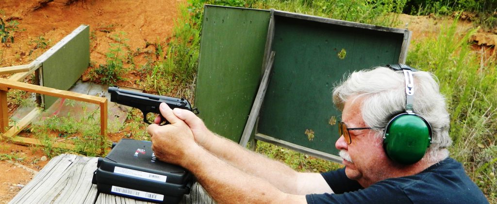 Bob Campbell firing syntech a pistol from a braced position