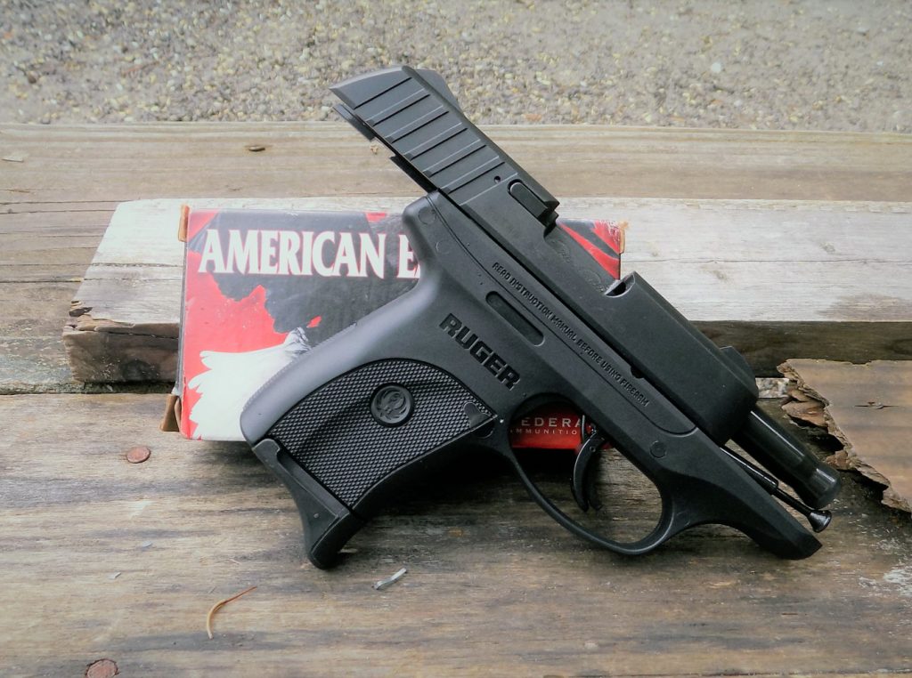 Ruger EC9s with slide locked back resting against a box of American Eagle ammunition