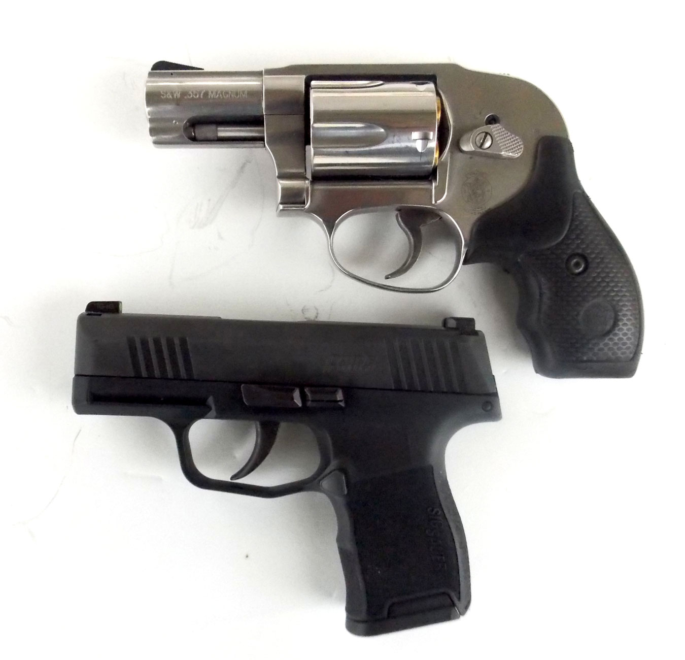 SIG P365 pistol (bottom) compared to a snub nose revolver.