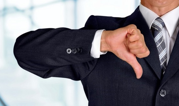 Man in business suit with a thumbs down gesture regarding Corporate America