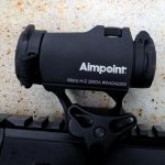 Aimpoint H2 light atop an AR rifle
