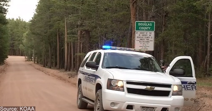 Armed Good Guys Police SUV with lights and siren parked by side of the road