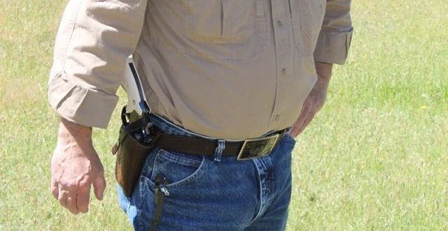 Man openly carrying a revolver in a holster for Constitutional Carry