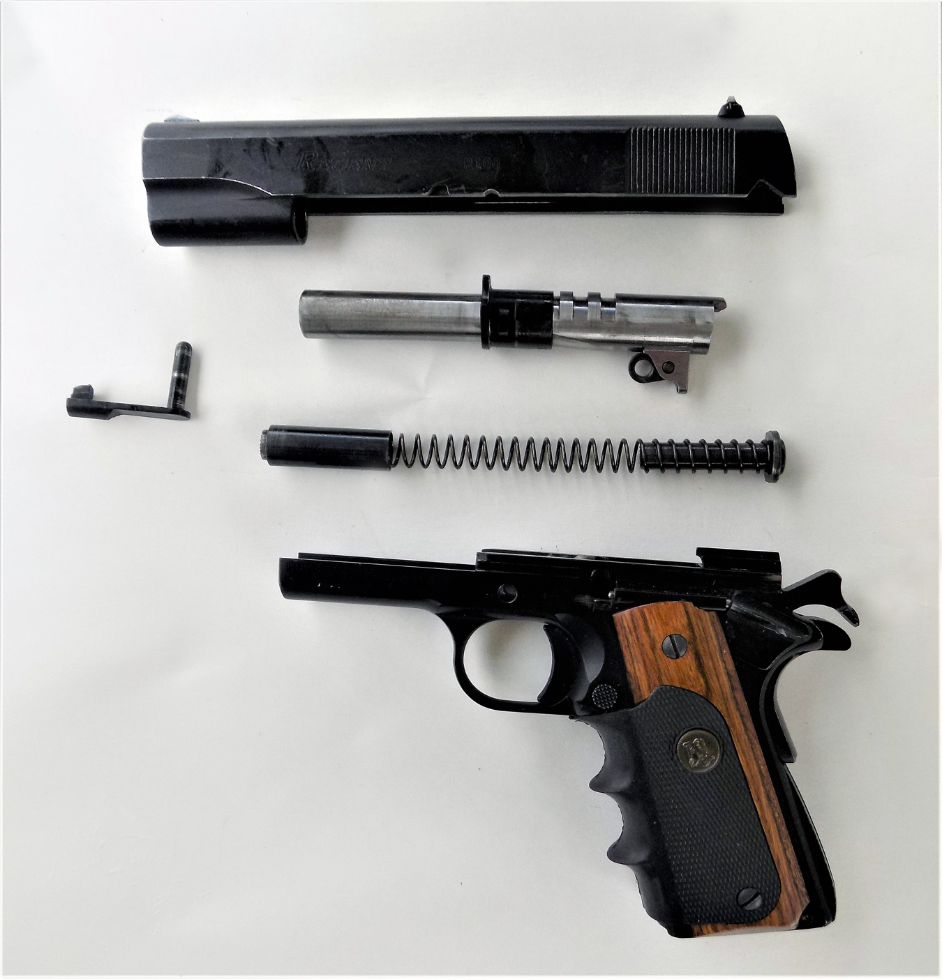 fieldstripped Regent R100 1911 handgun