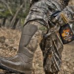 spraying rubber boots with scent killer