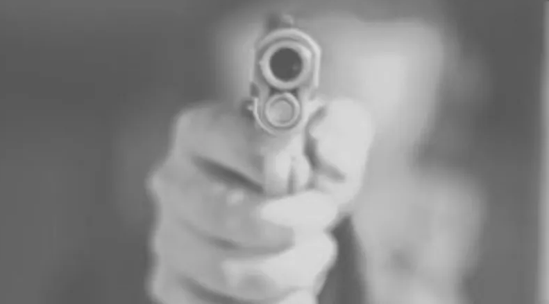 Armed good guy pointing a gun at the camera
