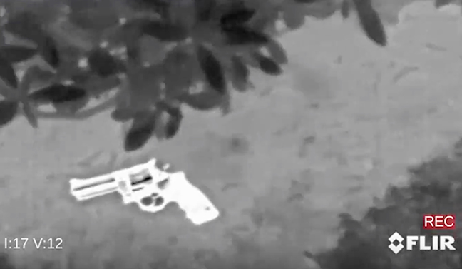 Thermal image of a gun on the ground