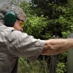 side view of Bob Campbell shooting one handed