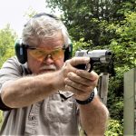 Bob Campbell firing with a two-handed grip