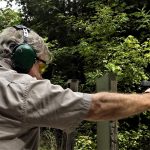 Bob Campbell shooting a handgun to lockback