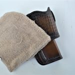 brown leather holster with cleaning cloth