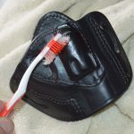 Cleaning a holster with a toothbrush