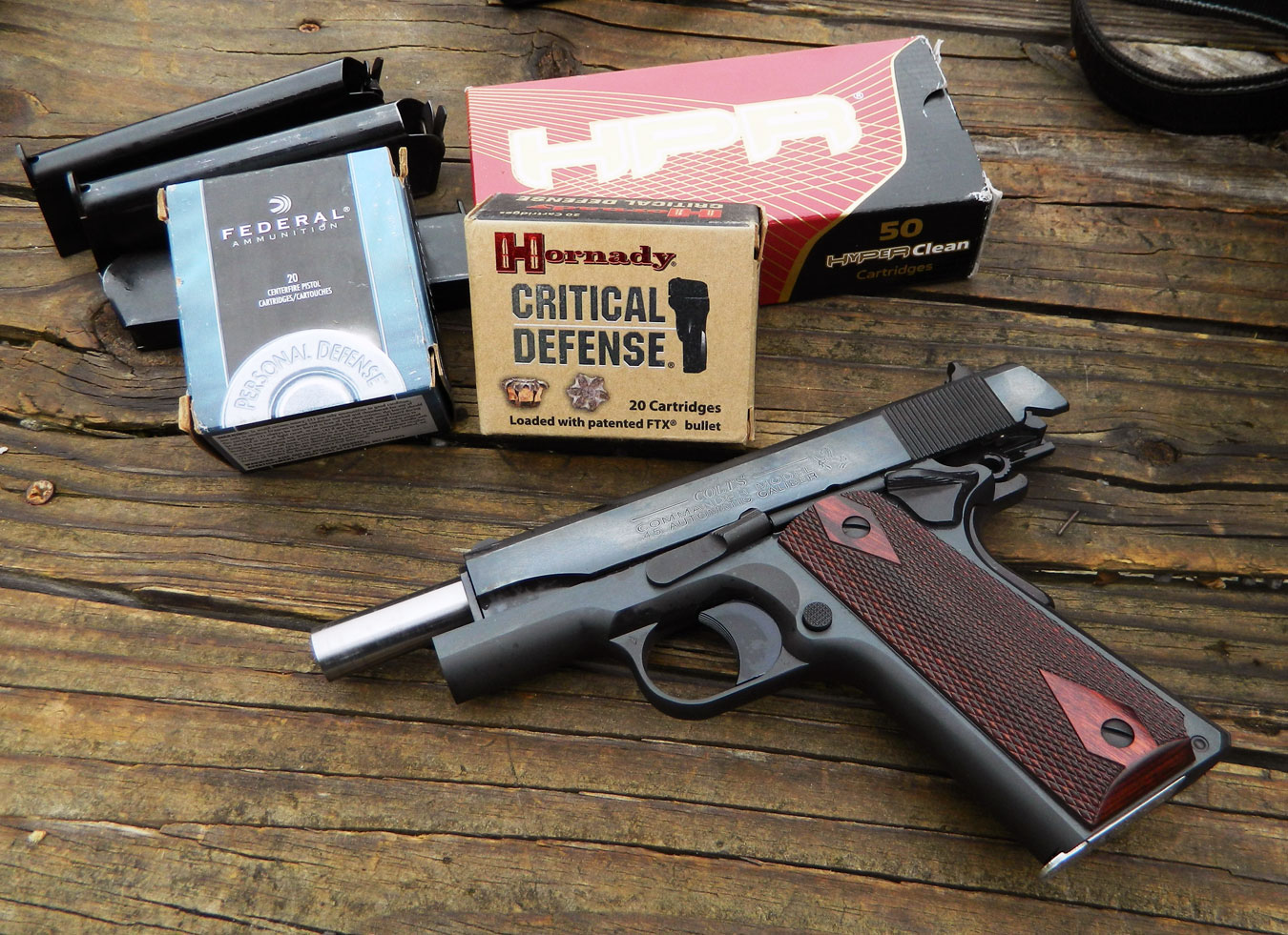 Colt 1911 pistol with three boxes of ammunition