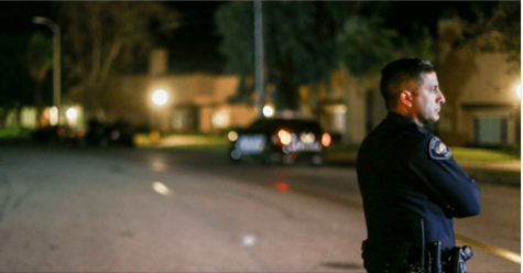 armed good guys Police officer guarding crime scene
