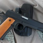 1911 handgun in .38 Super on top of a Kydex holster