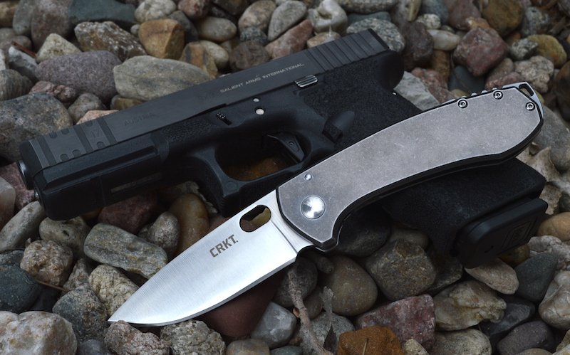 CRKT Amicus knife over a Glock pistol