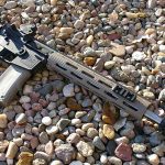 AR-15 right side on a bed of rocks