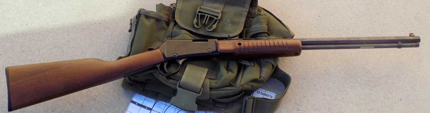 Henry Octagon pump rifle over an olive drab colored pouch