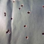 silhouette target with holes from a shotgun