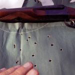 silhouette target with holes from a shotgun and Stoeger Coach Gun