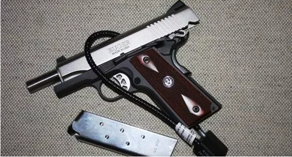 Ruger semi-automatic pistol with cable gun lock protesting preemption