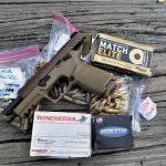 SIG P320 M17 with several boxes of ammunition