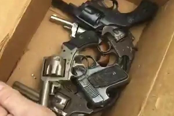 Box of old pistols and revolvers for gun buybacks