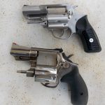 Two snubnose revolvers with the cylinders open