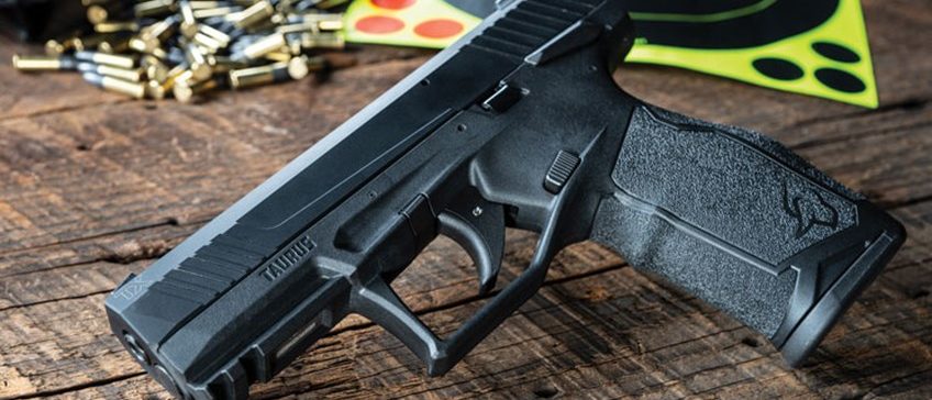 Taurus TX22 left angled on a wood background
