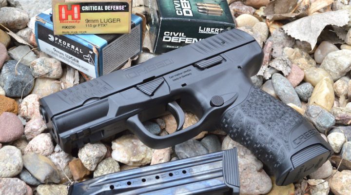 Walther Creed 9mm pistol left with spare magazine on bed of rocks