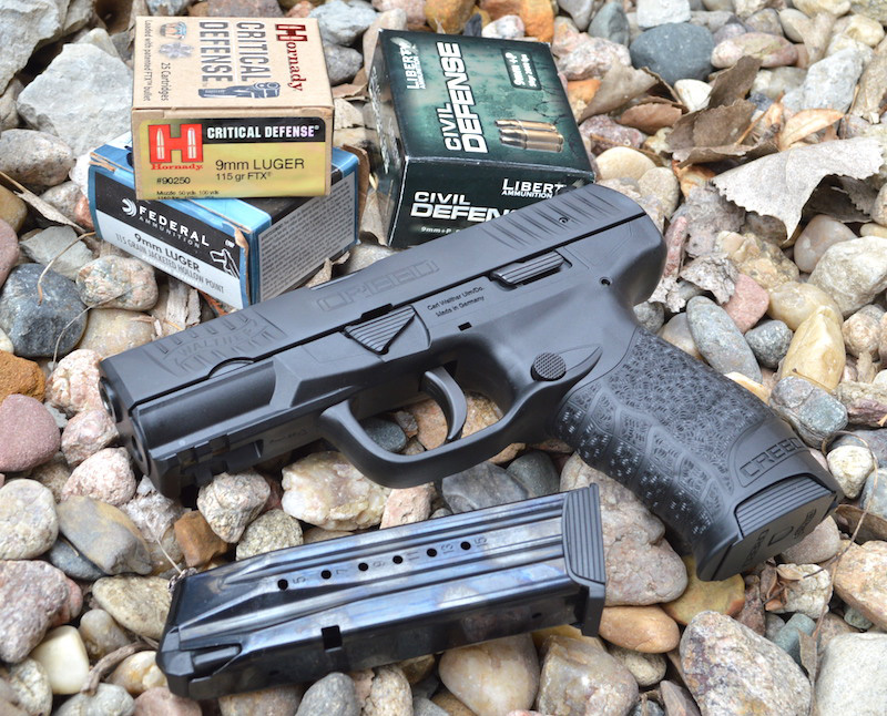 Walther Creed 9mm pistol left with spare magazine on bed of rocks