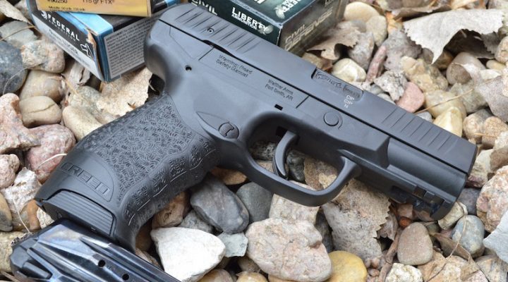 Walther Creed 9mm pistol right with a spare magazine and boxes of ammunition