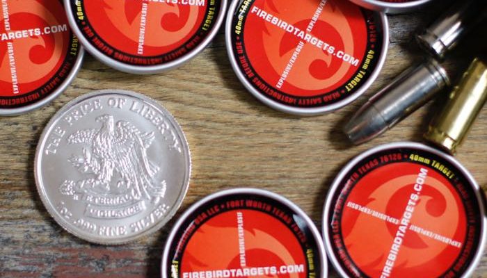 Firebird targets with silver dollar and loose rounds of ammunition