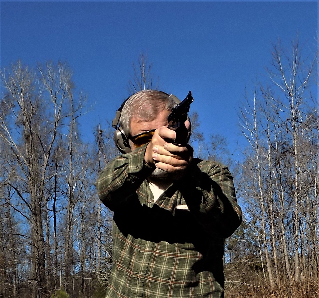 Firing a pistol with a two-hand grip